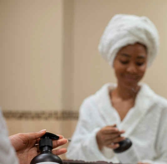 Woman in bathroom looking at shampoo bottle with concern 